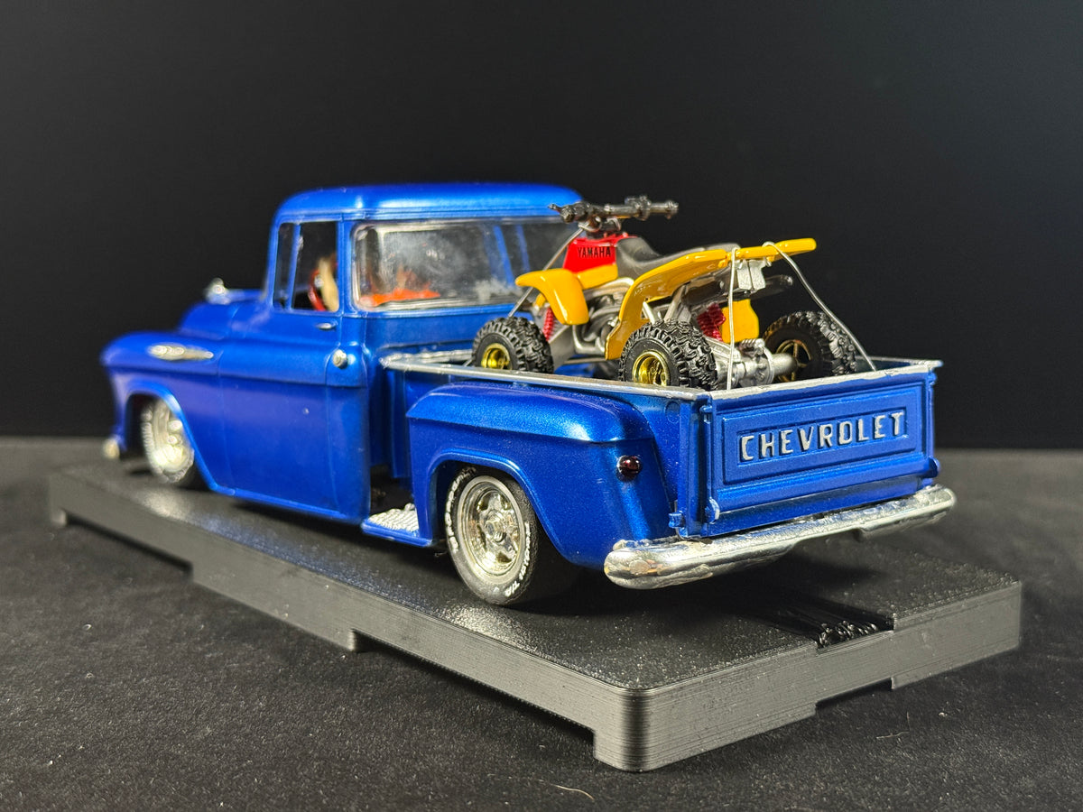 1957 Chevy Stepside slot car with miniature four-wheeler in pickup bed